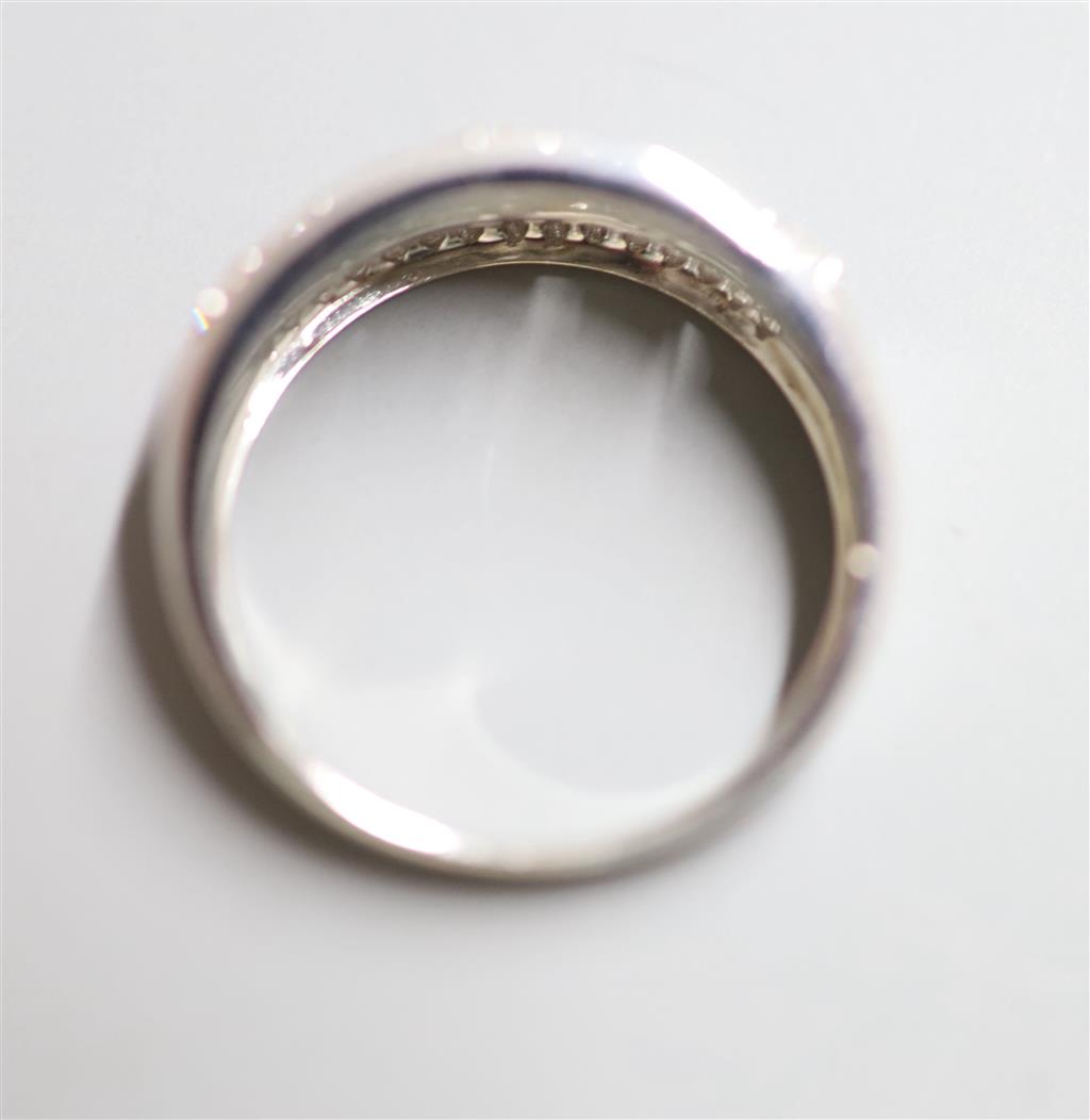 A modern 18ct white gold and graduated quintuple flower head cluster half hoop ring with diamond set border, size Q, gross 5.7 grams